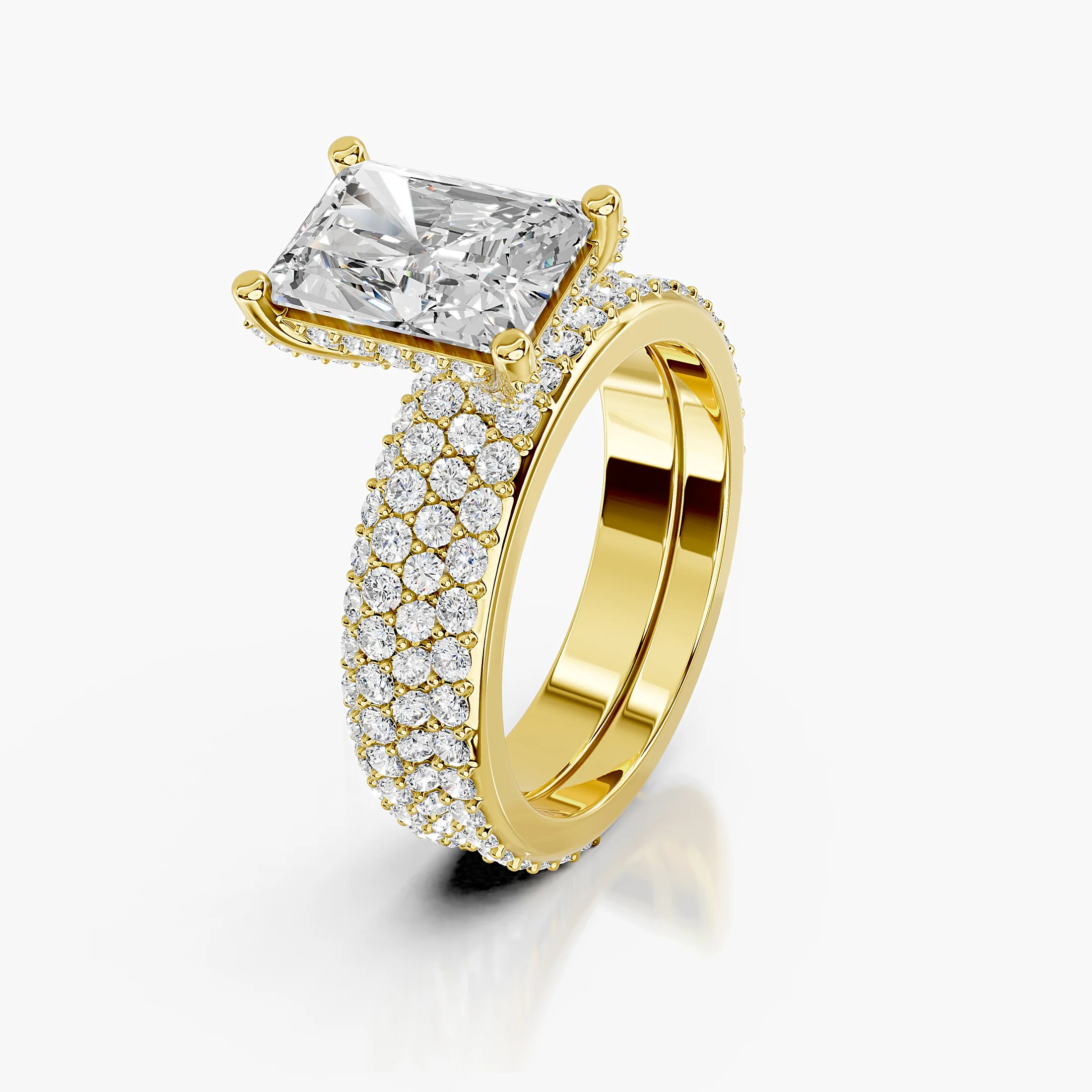 Radiant diamond pavé bridal set with a four-prong center and coordinating straight diamond band