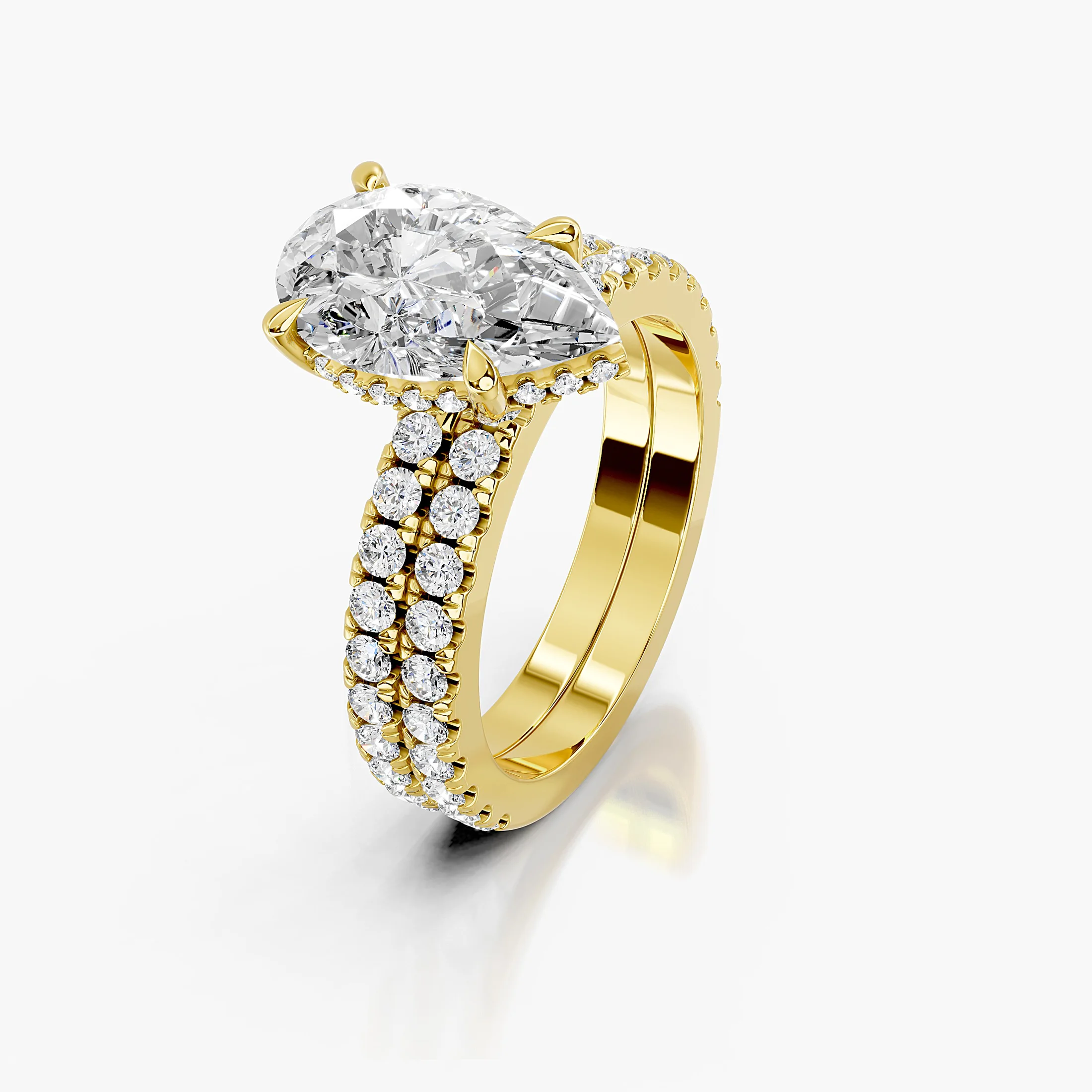 Pear-shaped hidden halo side-stone engagement ring with a coordinating straight diamond band shown as a two-piece bridal set