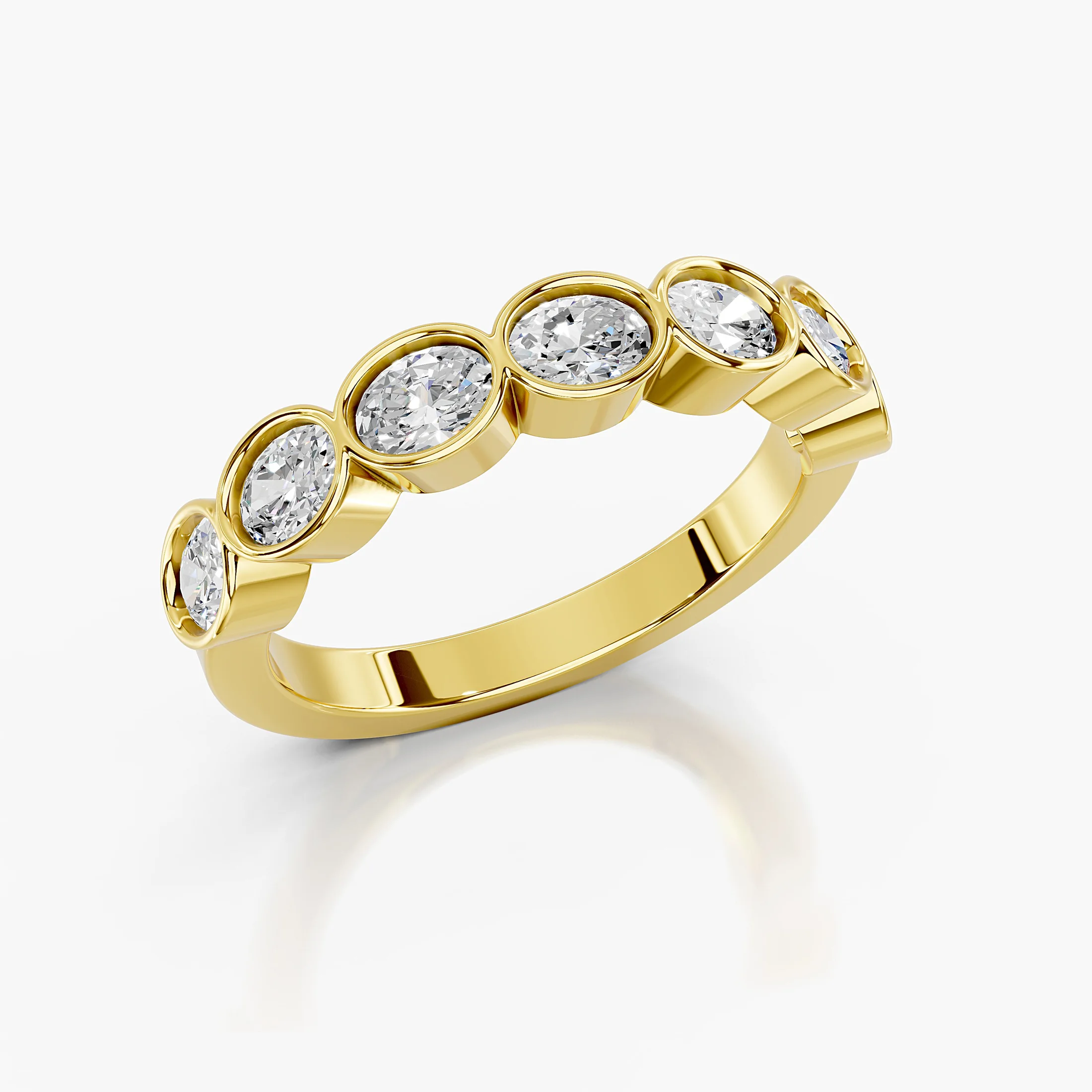 Wedding band featuring bezel-set oval diamonds arranged across a polished gold band.