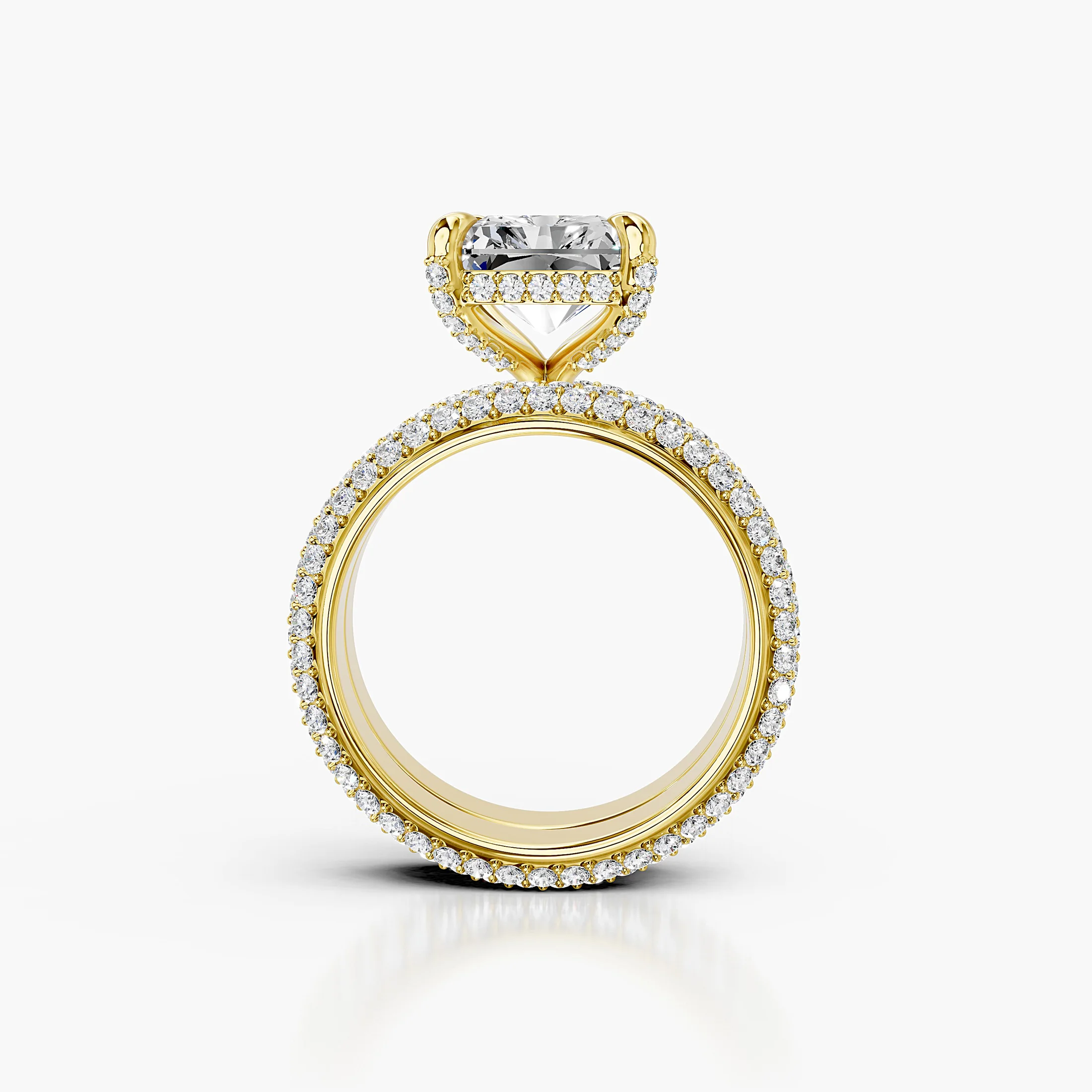 Solenne two-piece bridal ring set with an elongated radiant center, four-prong hidden-halo setting, multi-row round pavé, and straight coordinating band.