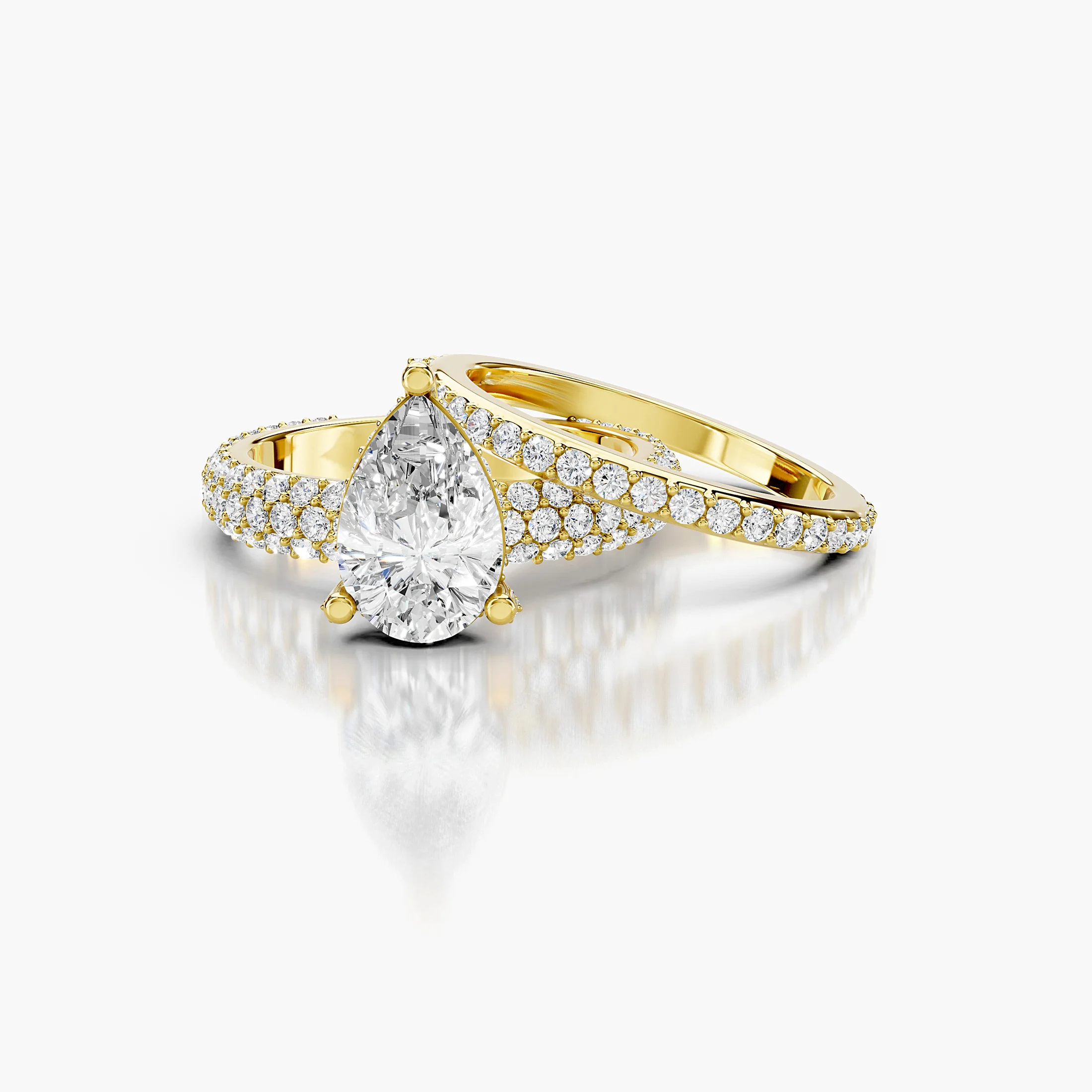 Pear diamond pavé bridal set with a prong-set center and layered curved diamond bands