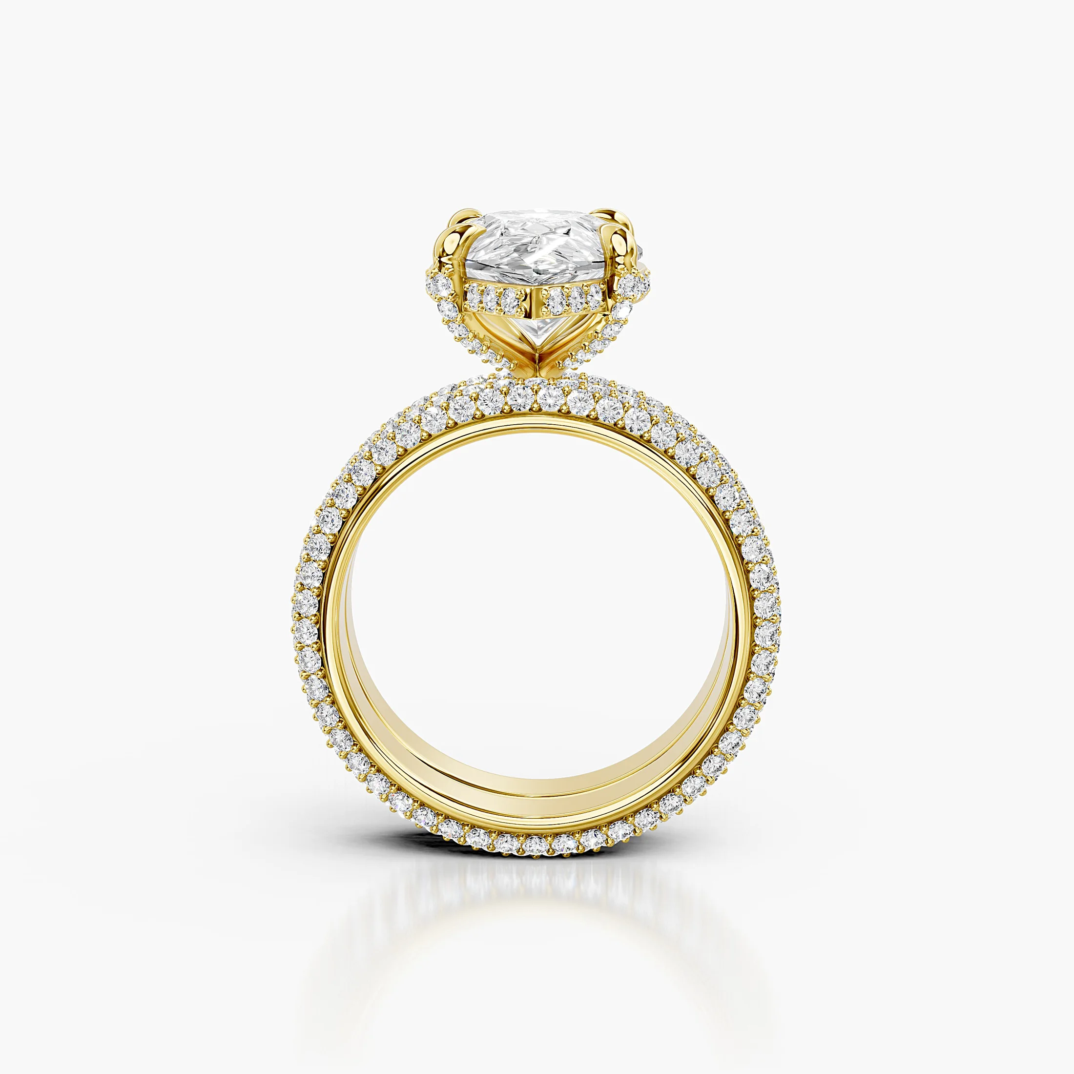 Pear-shaped center in a four-prong hidden-halo bridal set with round pavé shanks and a straight coordinating diamond band.