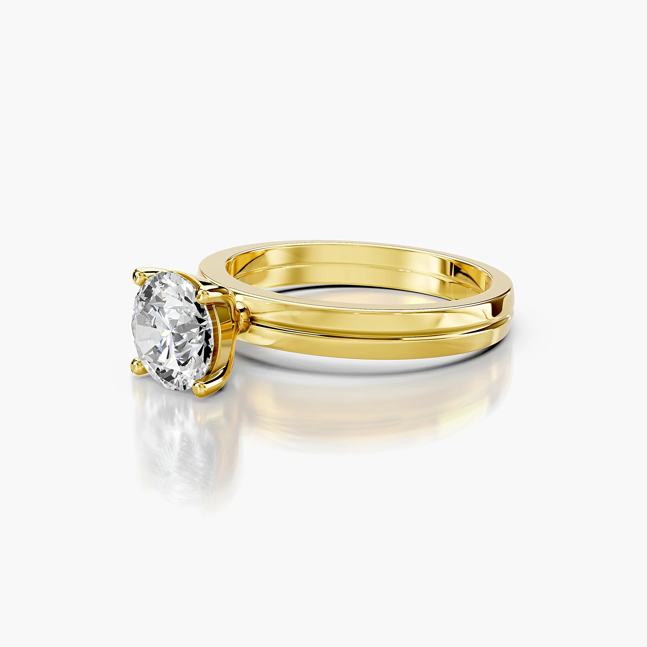 Round diamond solitaire ring on a grooved, split-profile gold band.