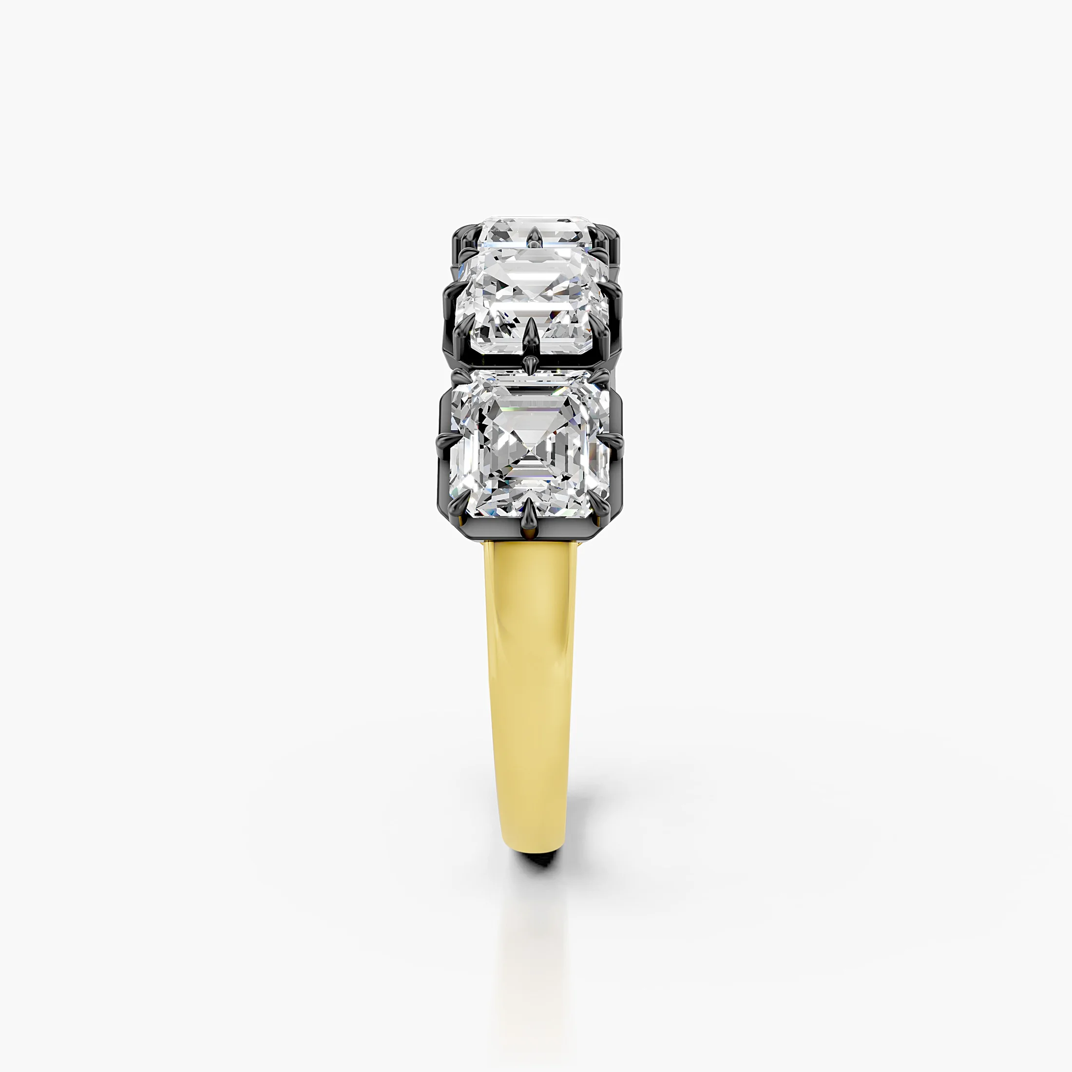 Statement ring featuring five Asscher-cut diamonds set in dark contrast prongs on a polished gold band.