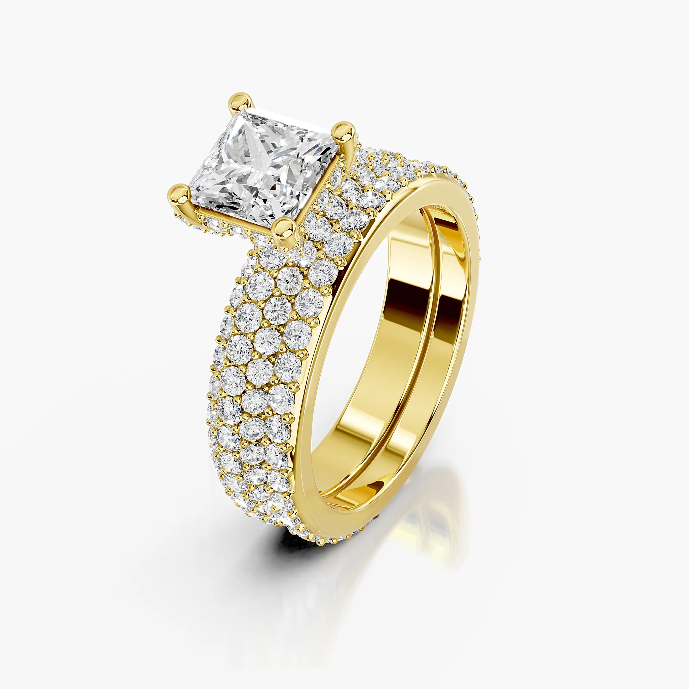 Princess diamond pavé bridal set with a four-prong center and coordinating straight diamond band