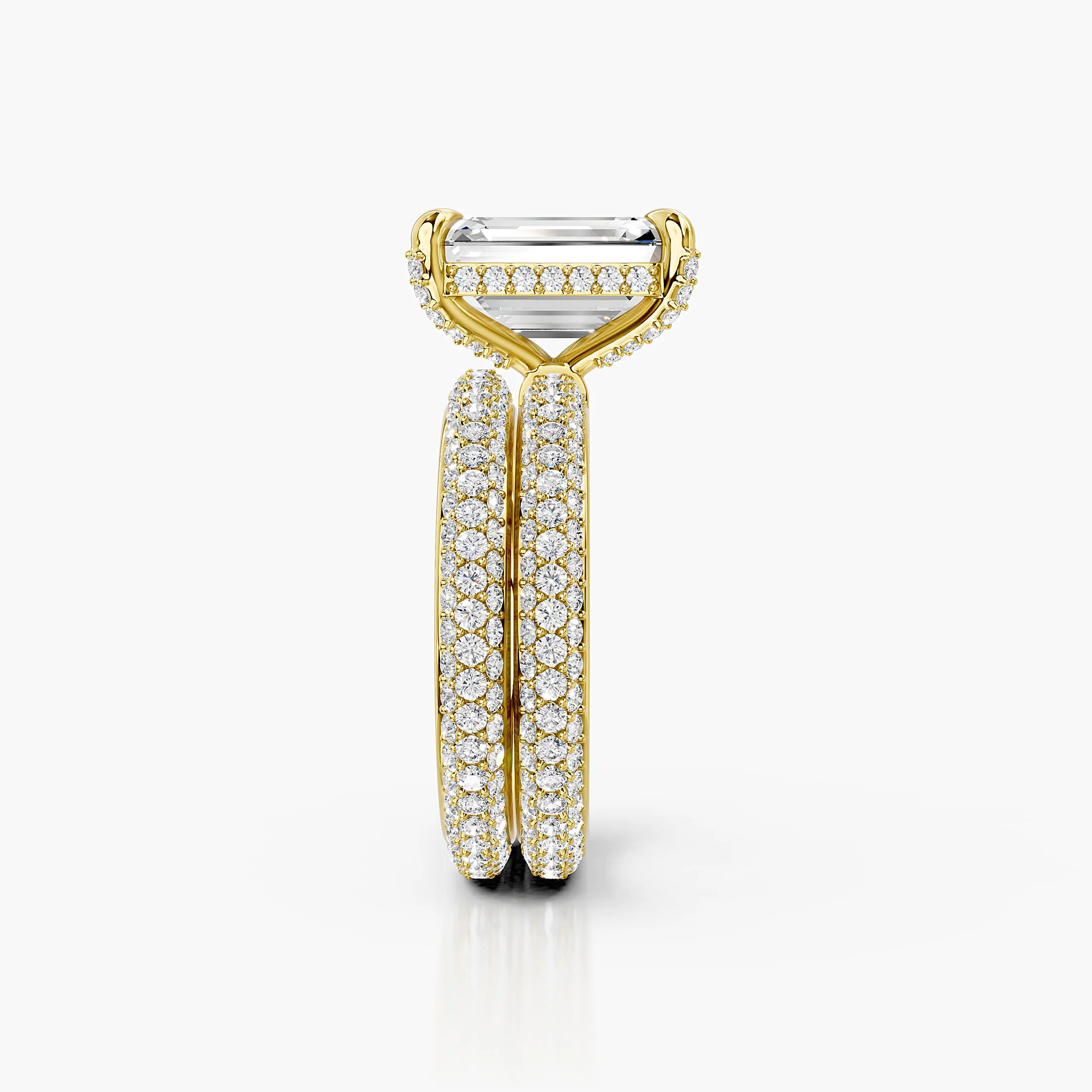 Two-piece bridal set featuring an emerald-cut center stone in a pavé-set diamond band.